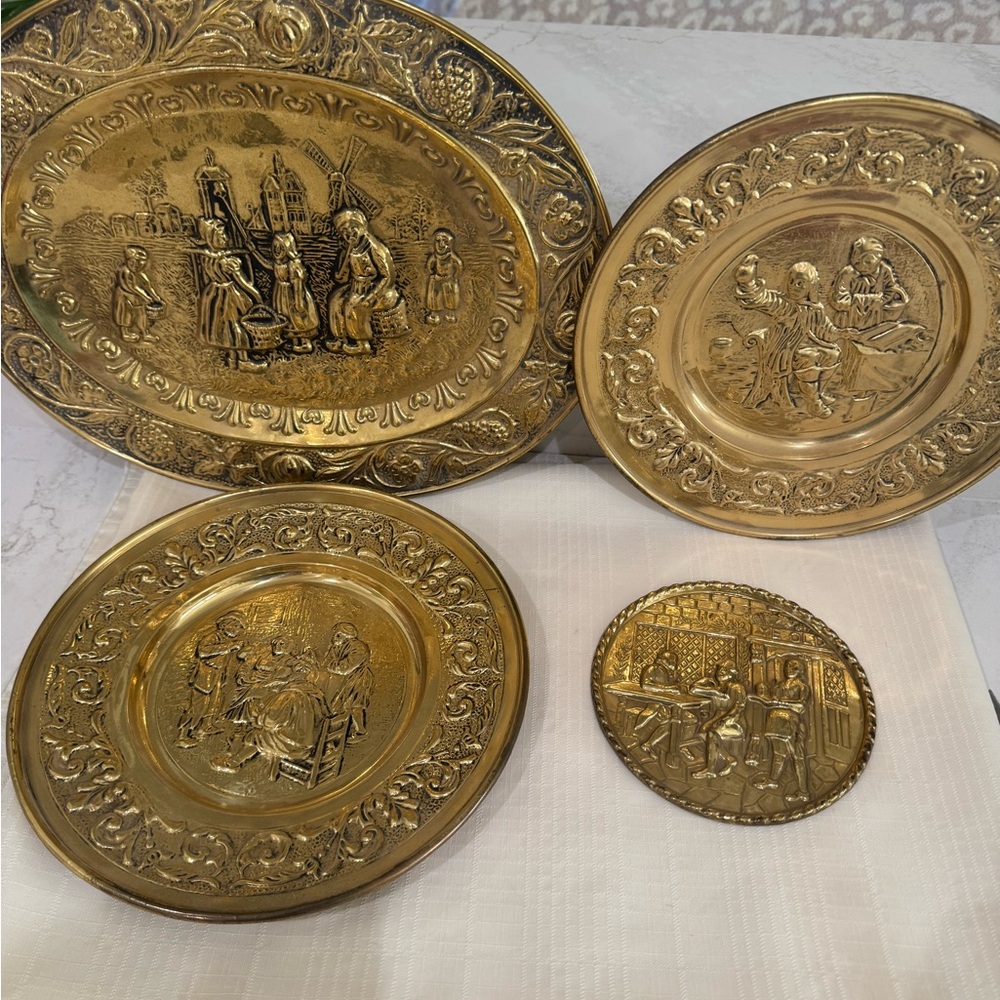 Vintage embossed or repoussé brass wall plates,